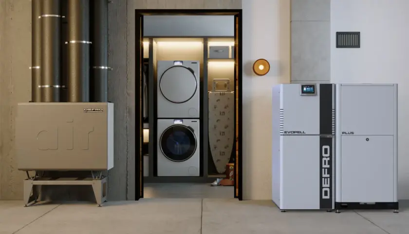 Nowoczesne kotły i systemy grzewcze od producenta pieców Defro. W tle pralko-suszarka i deska do prasowania.