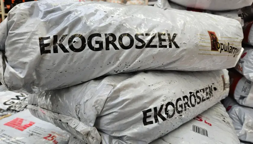 Stos worków z ekogroszkiem, gotowych do ogrzania domu.